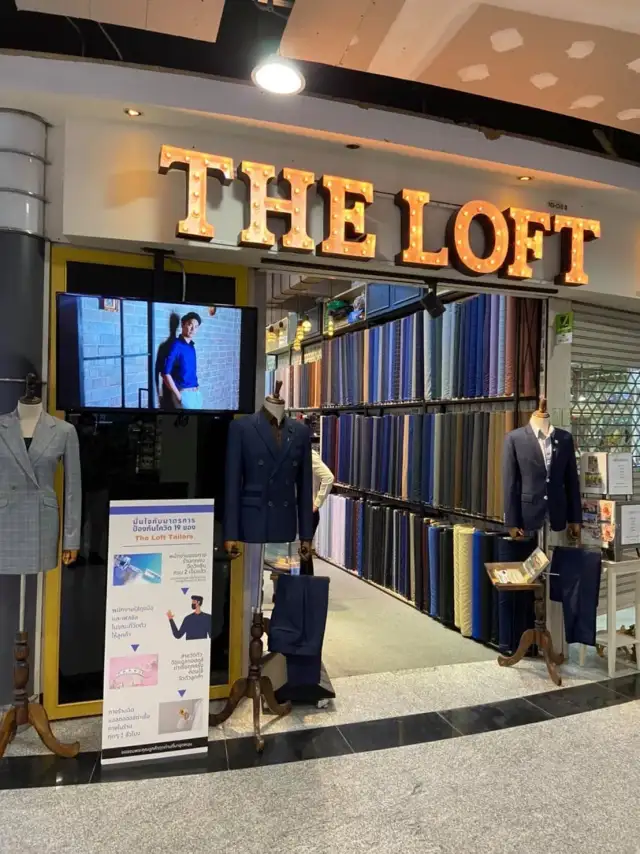 An earlier Loft shopfront at night, window displays lit and the sign above