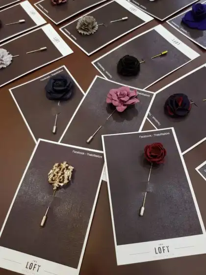 Floral lapel pins and long-stemmed brooches displayed on cards