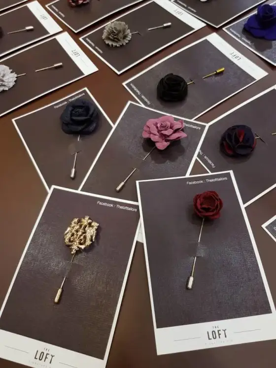 Floral lapel pins and long-stemmed brooches displayed on cards