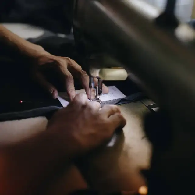 Hands pinning and chalking a panel of cloth