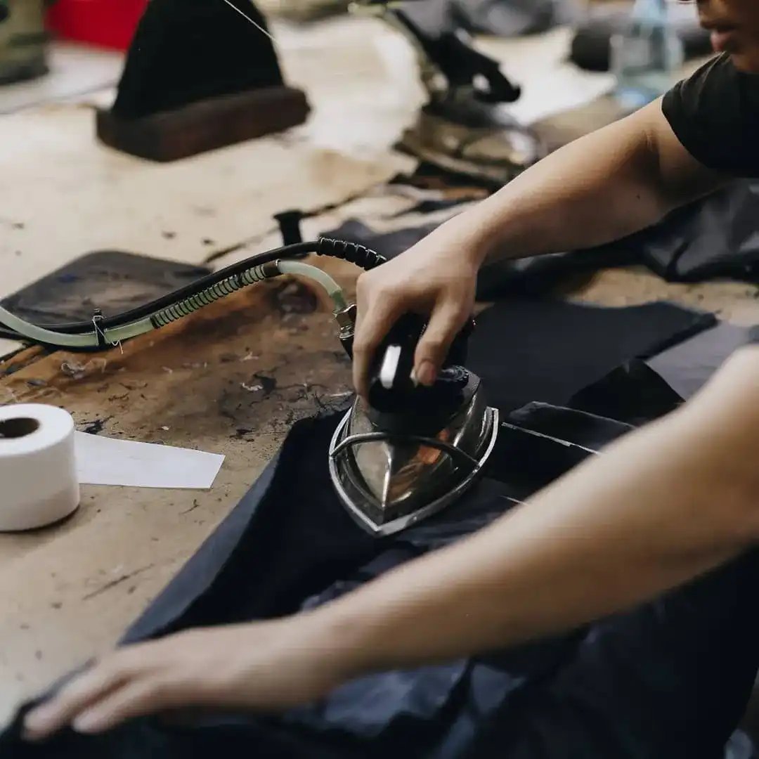 A jacket being pressed on the table at The Loft.