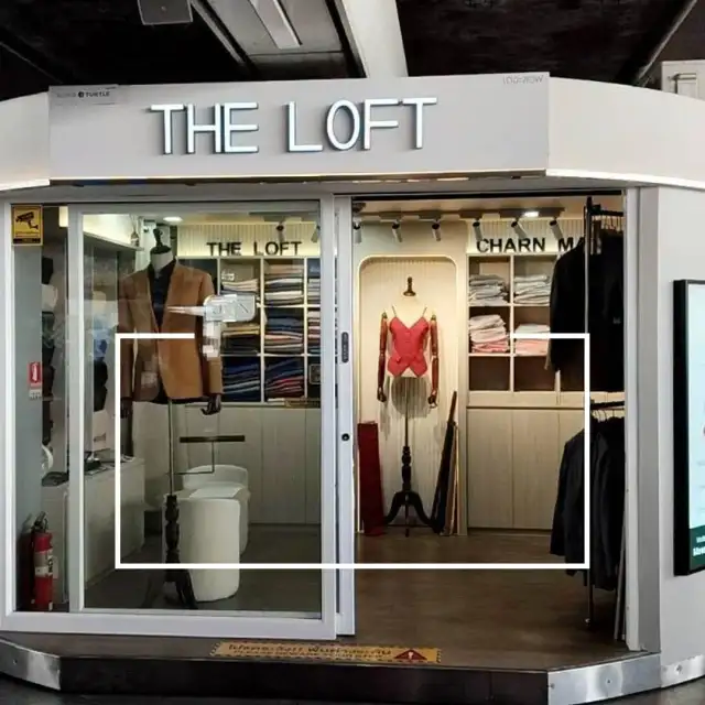 The Loft shopfront inside the station, mannequins and a fabric display either side of the entrance