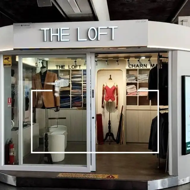 The Loft shopfront inside the station, mannequins and a fabric display either side of the entrance