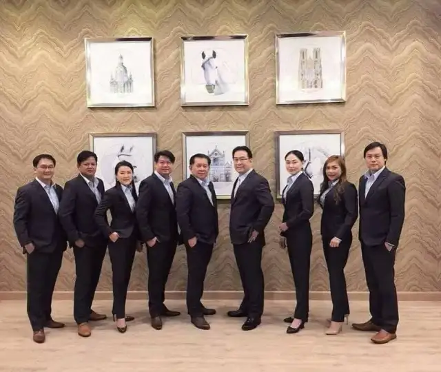 The Loft team photographed as a group in matching navy tailoring