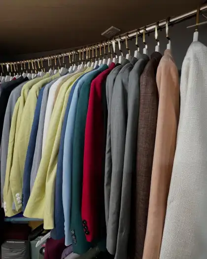 A long rail of jackets in many colours along the shop wall