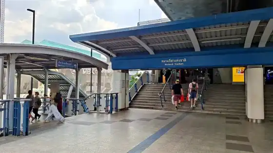 The skywalk sign for MBK Center beside the National Stadium station entrance and its stairs
