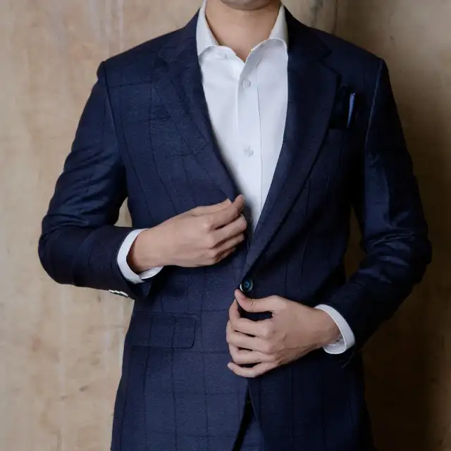 A navy windowpane check jacket worn over a white shirt