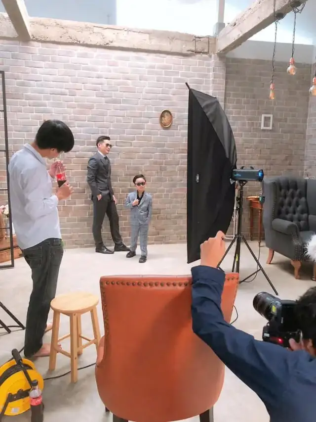 A photography set being lit inside the shop, chair and backdrop in place