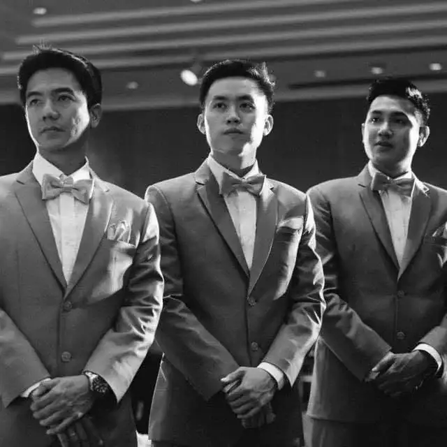 Three men in tuxedos and bow ties photographed in black and white
