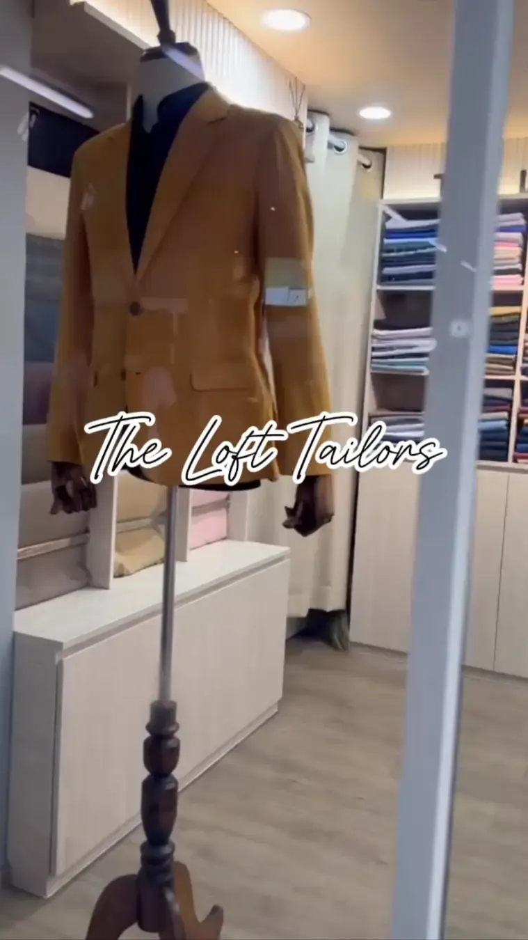 A tan jacket on a mannequin inside the shop