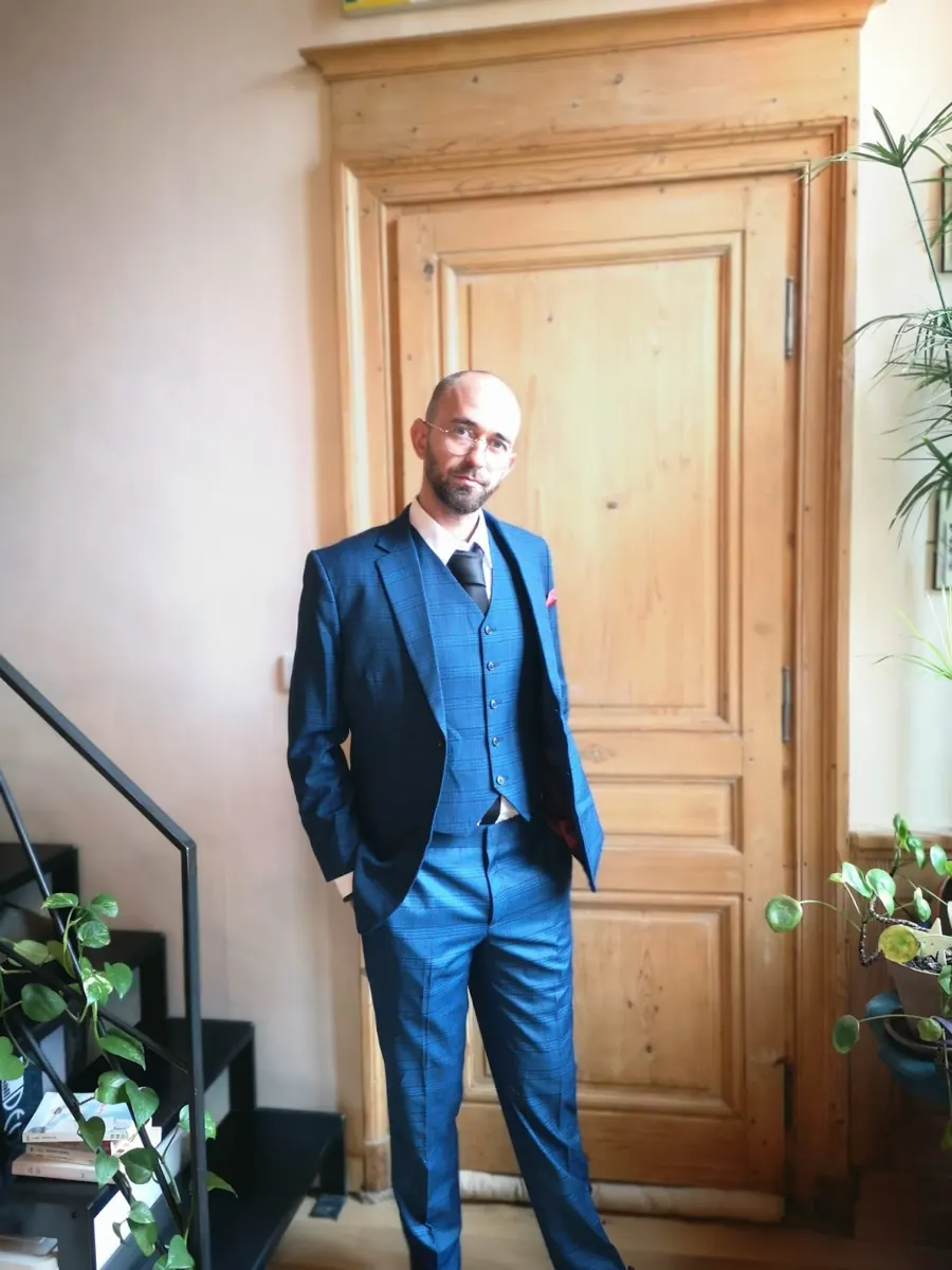 A customer wearing a finished blue three-piece suit